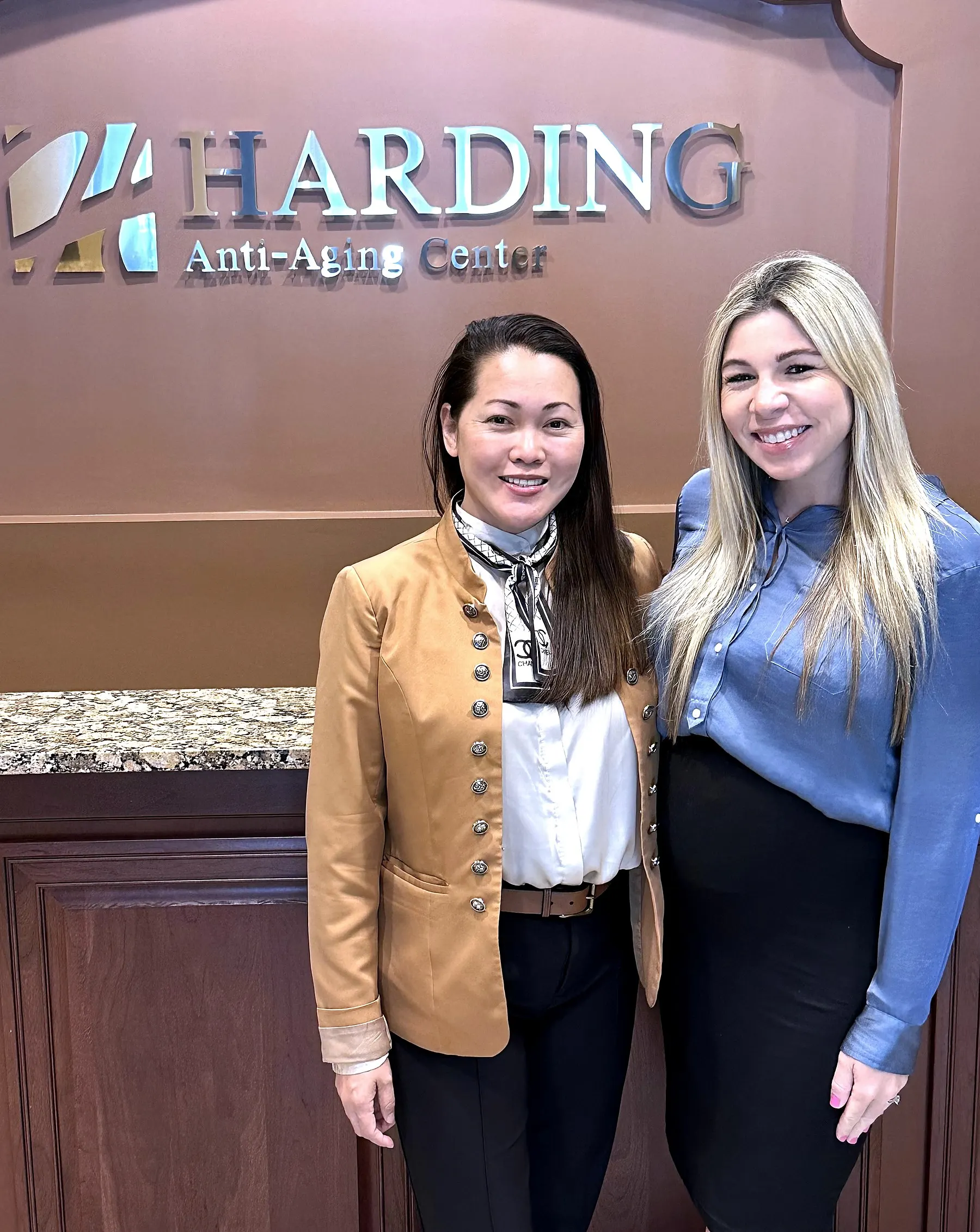 Rowena Montojo-Weiss, ARNP and Natalie Leonard, APRN together at the Harding Medical Institute front desk